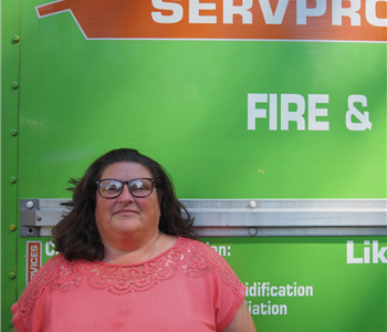 SERVPRO employee pictured in front of green background