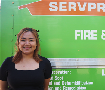 SERVPRO employee in front of green background