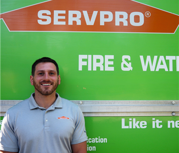 SERVPRO employee pictured in front of green background