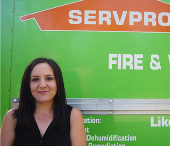 SERVPRO employee pictured in front of green background