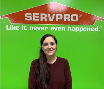 Lindsey, office secretary, pictured in front of SERVPRO logo 