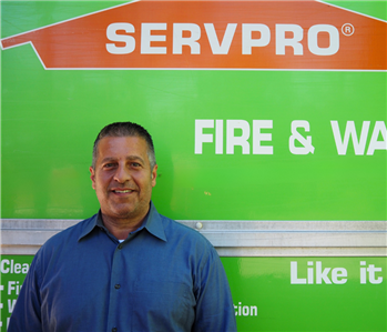 SERVPRO employee in front of green background