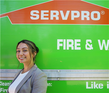 SERVPRO employee pictured in front of green background