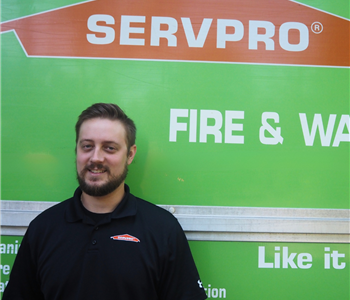 SERVPRO employee pictured in front of green background