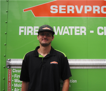 SERVPRO employee in front of green background